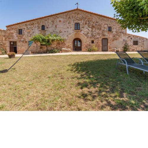 Catalan farmhouse with round pool in the middle of forest